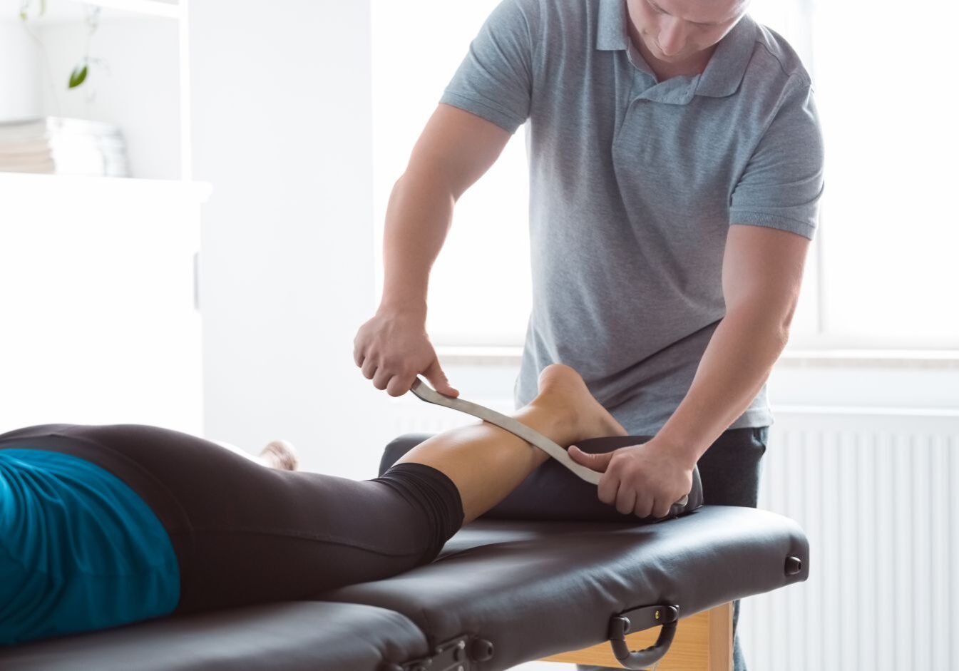 physical therapist massaging patient